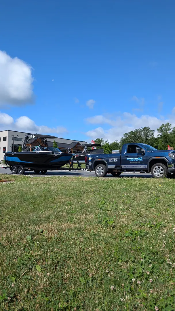 An Off Shore Marine truck hooked to a customer's boat.